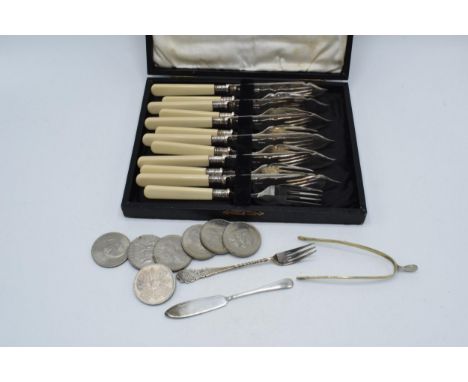 A cased set of silver plated knives and forks together with plated wishbone tongs and others together with 7 commemorative co