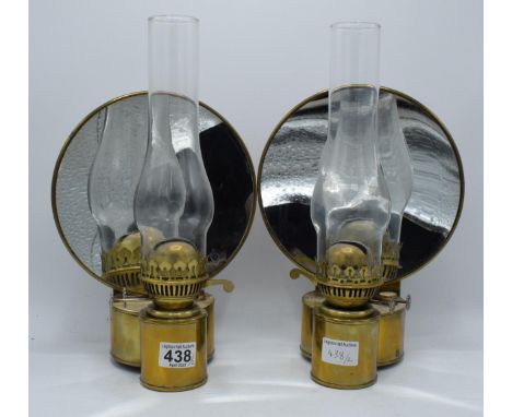 A pair of wall mounted oil lamps with magnifying mirror back lenses. Scratch built by a skilled engineer. Dating from the ear