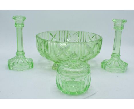 Mid 20th century Uranium glass dressing table set to include large bowl, a pair of candlesticks and a trinket (4).  Generally