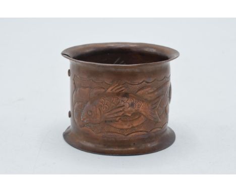 Arts and Crafts copper napkin ring, in the style of Newlyn, decorated with fish, with copper rivets, 5.5cm diameter.  