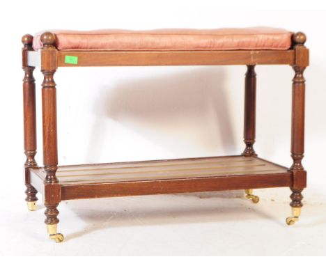 A Victorian revival mahogany hall buffet table / bench. The table raised on turned supports with castors, having a lower tier