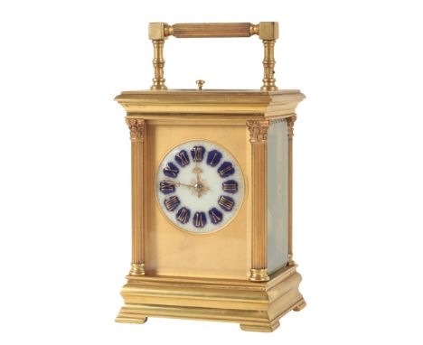 A FRENCH BRASS CARRIAGE CLOCK with enamel dial and blue and gilt enamel roman numerals, the case with fluted column corners w