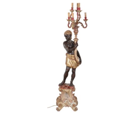 A 20TH CENTURY GILT AND PAINTED WOOD ELECTRIC STANDARD LAMP OF 'VENETIAN MOORISH' DESIGN the standing figure on leaf capped b