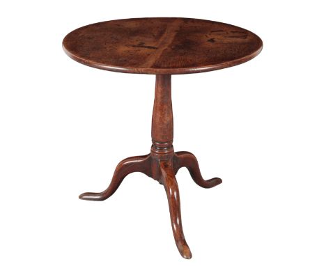 A GEORGE III OAK TRIPOD TABLE the circular tilt top on a baluster turned stem, to downswept legs and pad feet, 70cm high x 73