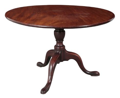 A GEORGE III MAHOGANY TRIPOD TABLE 18th century, the tilt-top on a shortened baluster turned stem, to cabriole legs and pad f