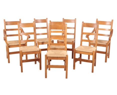 AN OAK DINING SUITE 20th century, including eight ladder back, rush-seated chairs, two of which armchairs, 102.5cm x 61cm, an