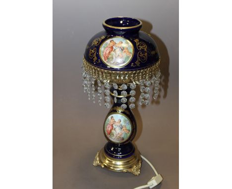 A MODERN GILT BLUE GLASS LAMP WITH FIGURATIVE DETAIL