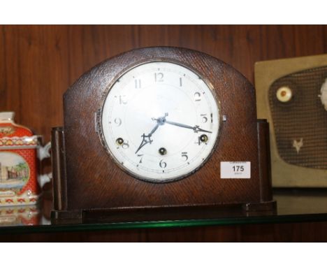 AN OAK DOME TOPPED ANVIL MANTEL CLOCK