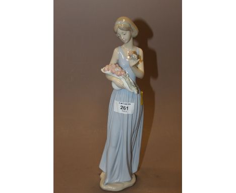 A NAO FIGURE OF A LADY WITH FLOWERS