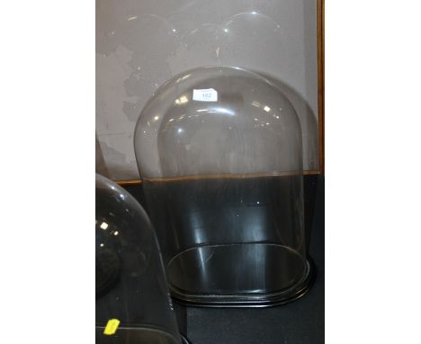 A LARGE GLASS CLOCK DOME AND STAND