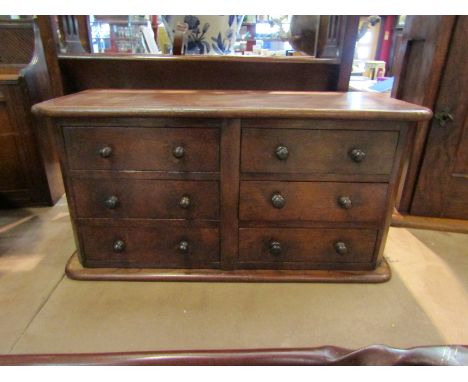 A mahogany six drawer table to collectors cabinet, 48cm long x 25cm tall 