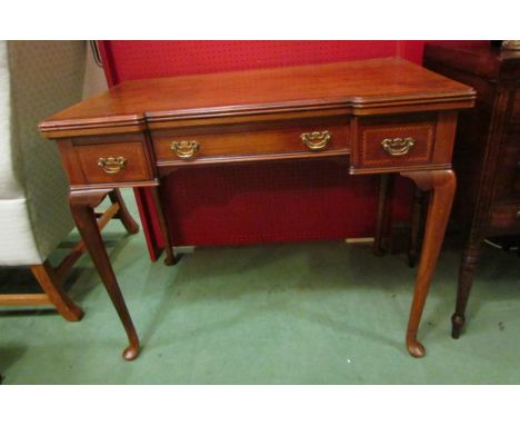 A 19th Century crossbanded inlaid walnut break front games table stamped 'Maple &amp; Co.' the hinged fold over top with thre
