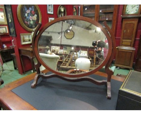 A matched pair of oval dressing table mirrors