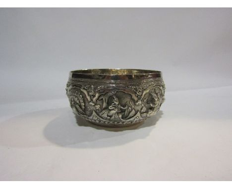 A Thai silver repousse relief bowl depicting various deities. 12cm diameter