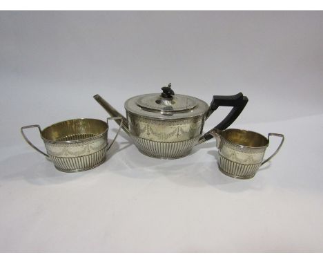 A late Victorian silver tease reeded and engraved with swags comprising of; teapot, milk jug and sugar bowl, Mappin &amp; Web