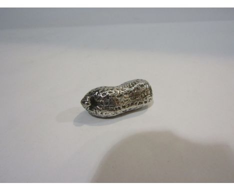 An unmarked silver model of a monkey nut
