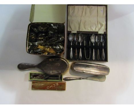 A tin box containing mostly souvenir spoons, a cased set of plated spoons with sugar tongs, a cased Hohner harmonica, silver 