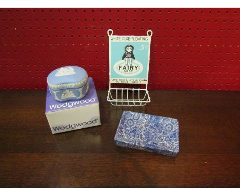 A Wedgwood Jasper ware lidded box, blue and white ceramic soap dish and a Fairy Soap advertising soap rack
