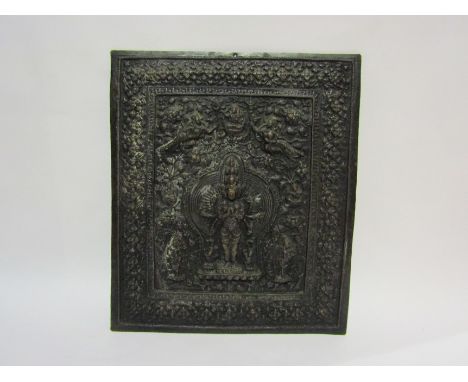 A hammered copper Tibetan plaque of a deity surrounded by figures, 33cm x 28cm