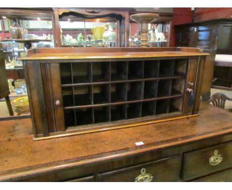 Circa 1860 a mahogany table top stationery cabinet the tambour front with working lock and key opening to reveal twenty four 