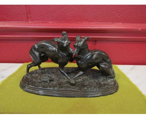 A 19th Century bronze effect figural group of lurchers playing ball beside tortoise