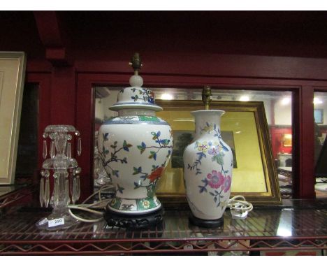 A poly chrome lamp in ginger jar form with wooden stand, together with another lamp in the form of a vase 