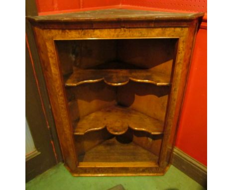 A George II style burr walnut corner shelf, 92cm tall   