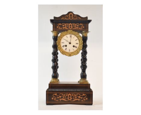 A late 19th century French portico clock, the 8.5 cm enamel dial with Roman numerals, fitted an eight day movement, in an inl