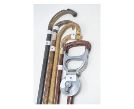 A horn handled walking cane, with a silver collar, 90 cm, three other walking canes and a shooting stick (5) 