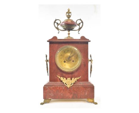 A late 19th century mantel clock, the 8.5 cm brass dial with Arabic numerals, fitted an eight day movement, in a red marble a