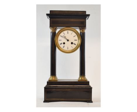 A late 19th century French portico clock, with 9.5 cm diameter enamel dial with Roman numerals, fitted an eight day movement,