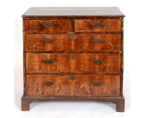 A George III chest, veneered in walnut, having two short and three graduated long drawers, on bracket feet, 95 cm wide See il