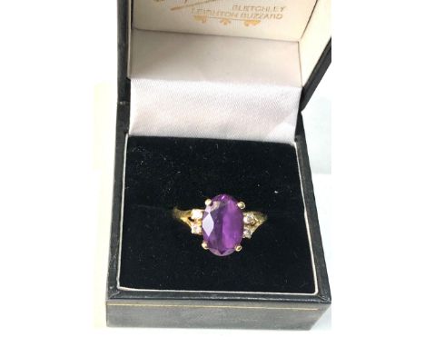 18ct gold diamond and Amethyst ring central amethyst measures approx 12mm by 8mm with diamonds each side weight 4 