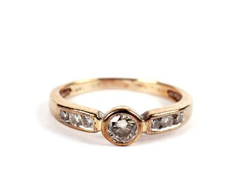 A solitaire diamond ring, the collet set round brilliant cut diamond weighing approximately 0.18carats, on diamond shoulders,