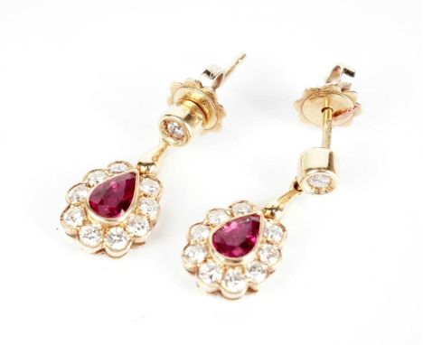 A pair of ruby and diamond drop earrings, in 18ct yellow gold mounts, 21mm high, 4.9g gross.
