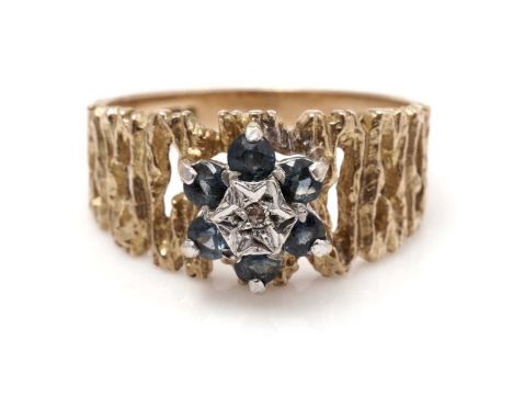 A diamond and sapphire cluster ring, on 9ct yellow gold bark effect shank, ring size N, 3.5g gross.