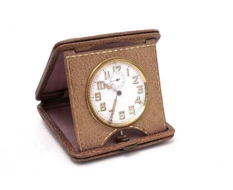 An early 20th Century travel clock, the white enamel arabic dial with subsidiary seconds aperture, in purple leather case.