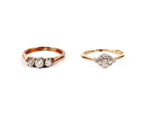 A diamond cluster ring, with marquise shaped bezel, stamped '18ct', size K, 1.4g gross; and a diamond three stone ring, in 9c