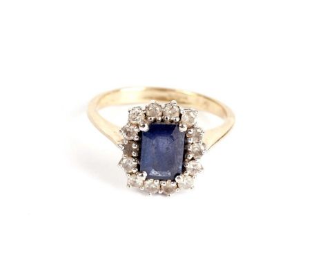 A sapphire and diamond cluster ring, the four claw mounted rectangular sapphire within a border of round brilliant cut diamon