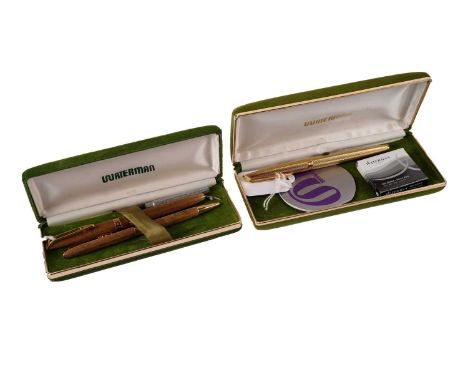 A pair of vintage Waterman gilt metal pens, comprising: a ball point pen, and a fountain pen with 18ct yellow gold nib, in Wa