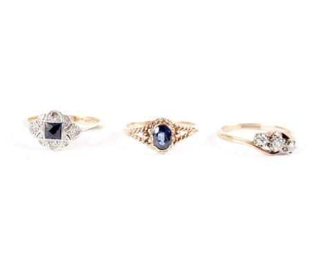A sapphire and diamond ring, in platinum mount and 18ct yellow gold shank, size N; a diamond three stone ring, in twist setti