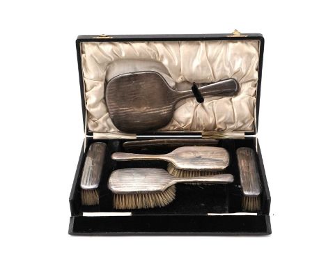 A George V silver dressing table set, by S. Blanckensee &amp; Son Ltd., Birmingham, 1923, comprising: two hairbrushes, two cl