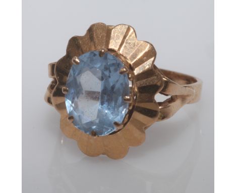 Pretty oval blue stone dress ring,probably a blue topaz, on unmarked shank, tests as 9ct gold.