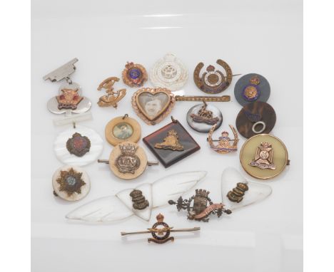 A collection of vintage miltary themed badges and fobs, 20 in the lot