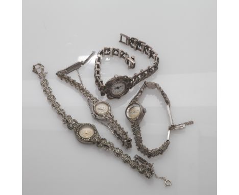 A group of four ladies marcasite set cocktail watches, three marked silver or sterling, one appears un marked.