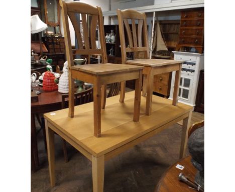 Light oak dining table and a pair of pine chairs 