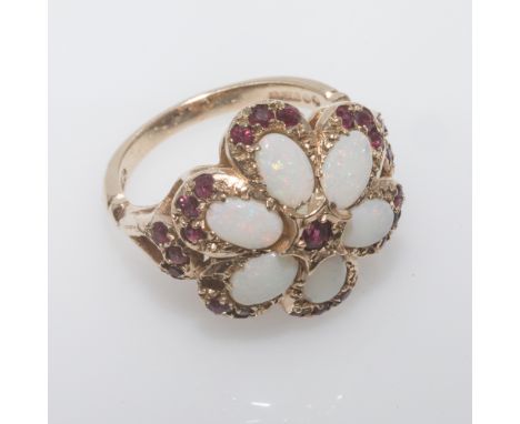 9ct gold opal and ruby cluster ring, set in a floral design, hallmarked shank,ring size o   the cluster is 2cms diameter, one