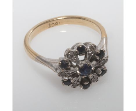 sapphire and diamond cluster ring, set in a floral design, shank stamped 18ct. Size K