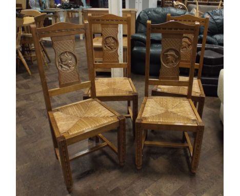 Set of four French carved light wood dining chairs with rush seats 