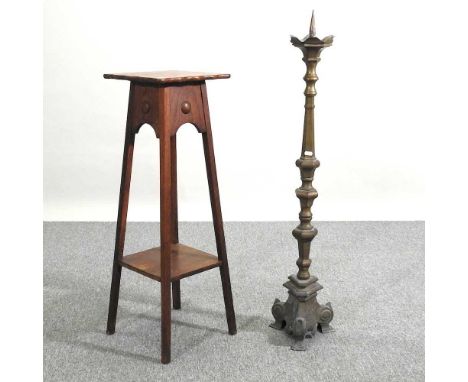 An Arts and Crafts oak jardiniere stand, together with a large brass altar stick, 111cm high (2)30w x 30d x 91h cm